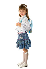 The little girl in a jeans skirt  with a backpack