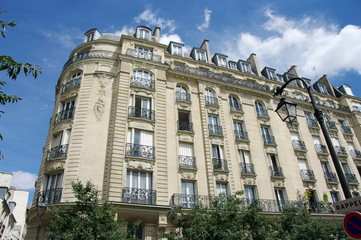 Immeuble de pierre blanche, ciel bleu, Paris.