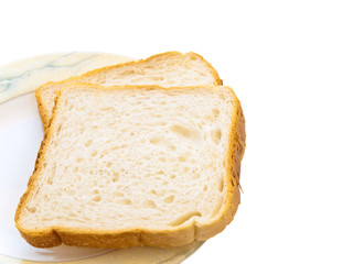 Two pieces of white bread at the plate