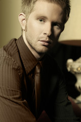 elegant young man in suit and tie staring