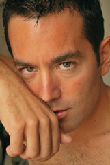 uomo con sguardo sensuale , mano sul viso