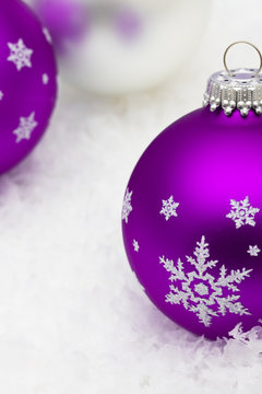 Purple And Silver Glass Christmas Balls On Snow Background