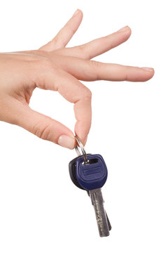 Close-up of keys held by forefinger and thumb