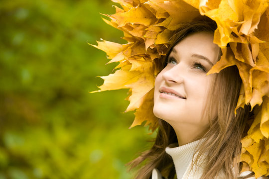 Image of beautiful girl with yellow wreath looking upwards