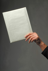 Man's hand with an envelope of white color