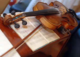 Fototapeta premium picture of wood violin on the table with notes