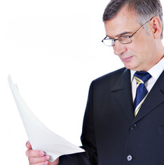 Businessman in suit and glasses reading