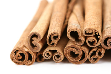 heap of cinnamon sticks isolated on white