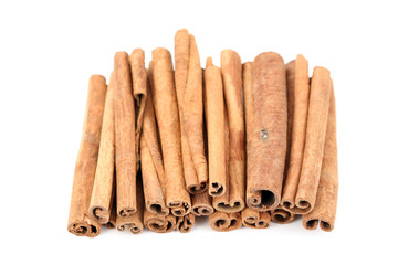 heap of cinnamon sticks isolated on white