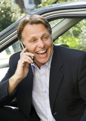 A happy smiling businessman on cellphone