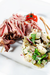 Roast Beef Served with Salad (Potatoes and Vegetables)