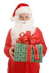 Santa Claus  in pajamas, holding a gift for you.  Isolated