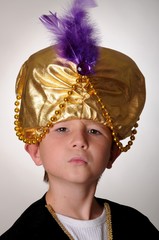 Young boy wearing a Sultan or Shiek's halloween costume.