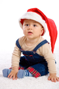 One year old baby boy in santa's hat.