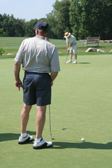 Obraz premium Active Seniors at Golf Practice Green