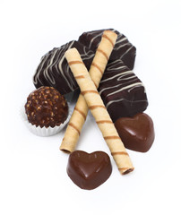 Chocolate and diverse pralines, isolated on white