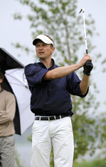 a golfer holding his finish after tee shot