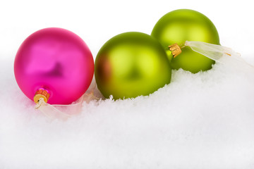 Pink and green, on a bed of snow against a white background