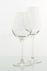 Two Empty wine glasses on a glass table