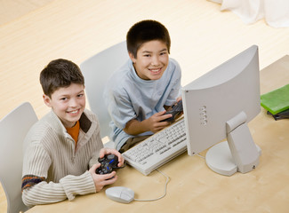Friends holding video game controllers playing video game