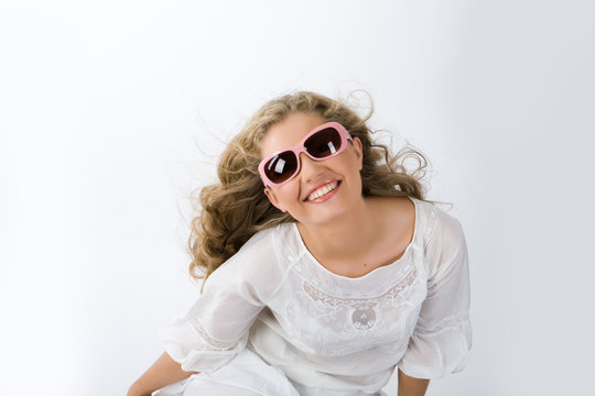 Young woman in white clothes with sunglasses