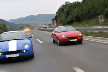 Plakat cars speeding on highway captured with long exposure