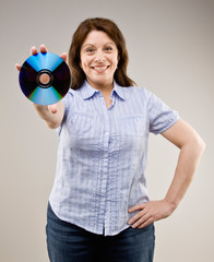 Confident woman proudly holding out compact disc