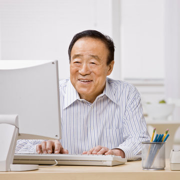 Confident man typing on computer
