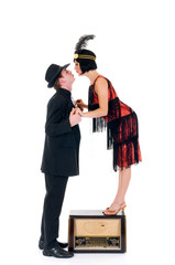 Attractive young couple, retro look with old radio.