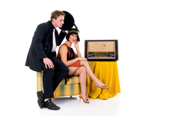 Attractive young couple, retro look with old radio.
