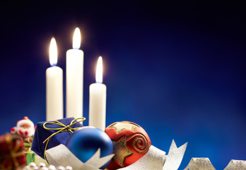 christmas bauble and candle light, blue background