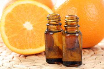 bottles of essential oils and some resh oranges