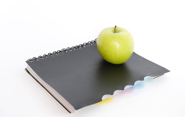 green apple and  book