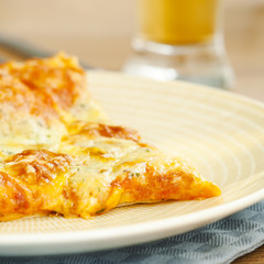 Hot pizza on the plate with cold beer