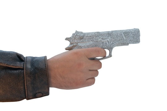 male hand with newspaper pistol on white background. fake