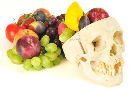 A human skull filled with fruits and vegetables