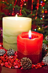 two Christmas candles and decorations