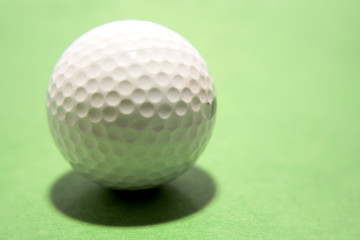 Golf ball on green background