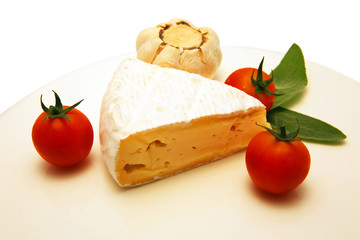 camembert cheese with tomato and garlic on white dish