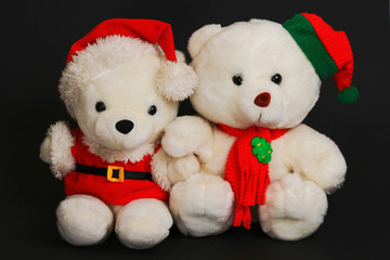 christmas teddy bears isolated in black background.