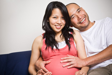 A shot of a happy asian couple expecting for their unborn baby