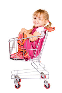 Little Girl Sitting In Shopping Cart Anxious To Go - Isolated