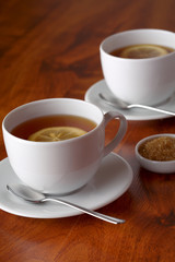 Hot teacup with lemon and sugar