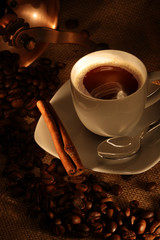 coffee cup with mill, fresh beans and cookies.