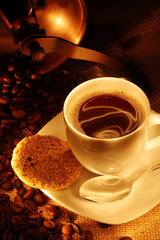 coffee cup with fresh beans and cookies.