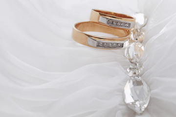 Closeup of wedding rings near decorative jewelry