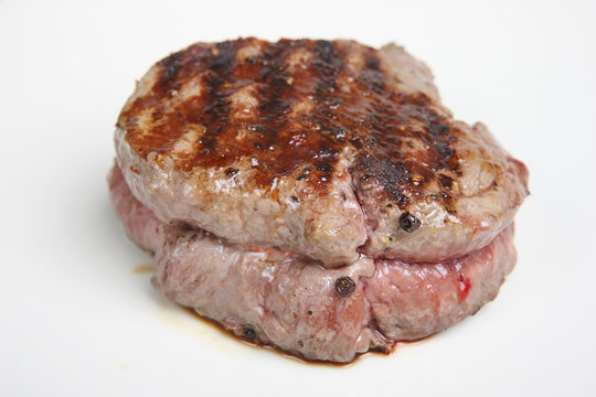 Rare fillet steak resting on a white plate.