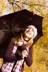 happy girl with an umbrella in the park