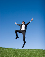 Businessman jumping in the air
