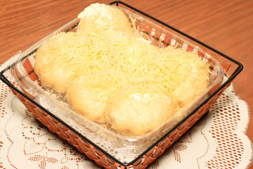 filipino sweet bread topped with lots of cheese and butter.